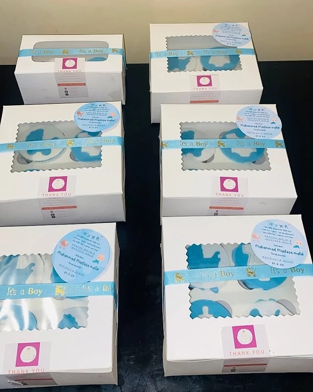 Bulk order cupcakes for baby boy celebration with 'It's a Boy' decorations and thank you messages - Baby Cupcakes Karachi By Whisk And Sift